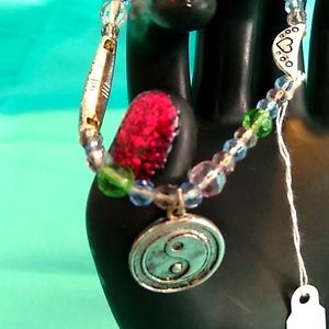 Oggie design silver accent in colored crystals.